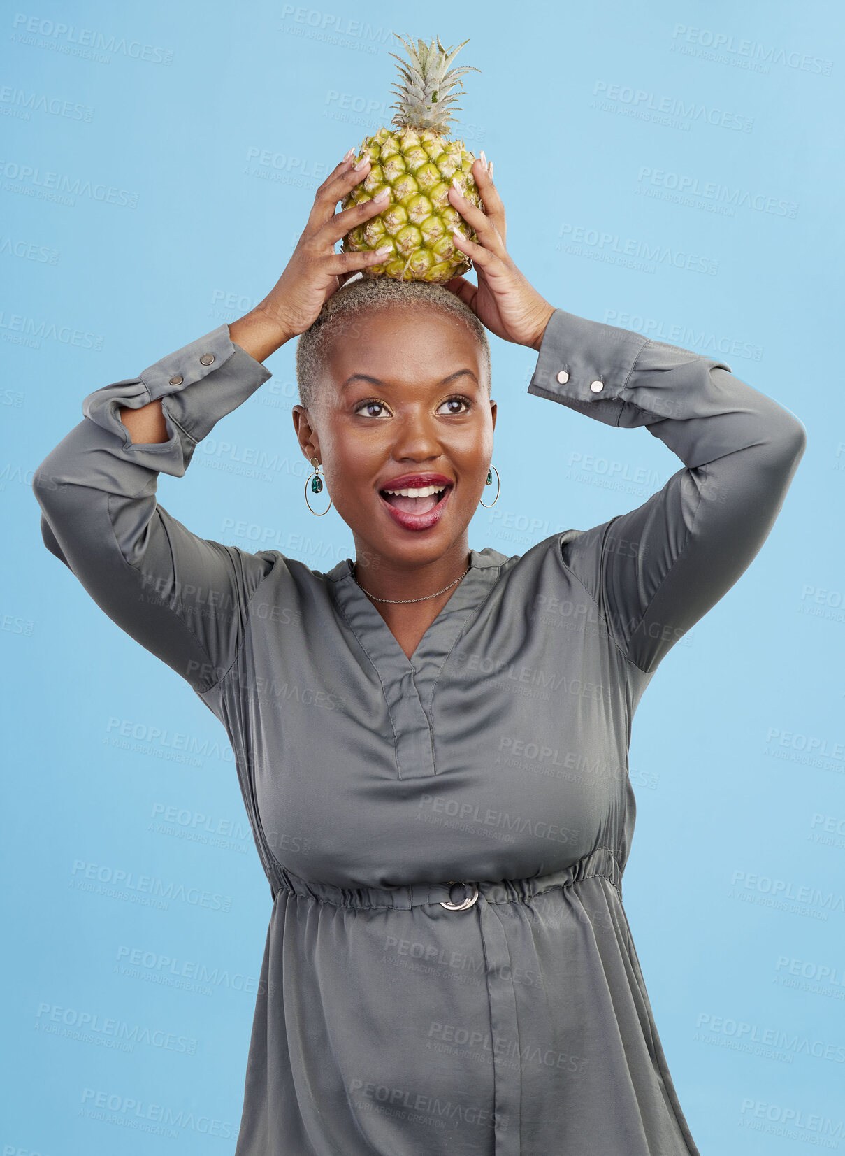 Buy stock photo Face, balance and black woman with pineapple in studio for detox, lose weight or diet nutrition on blue background. Fruit, care and African lady nutritionist show vegan, organic and diet snack choice