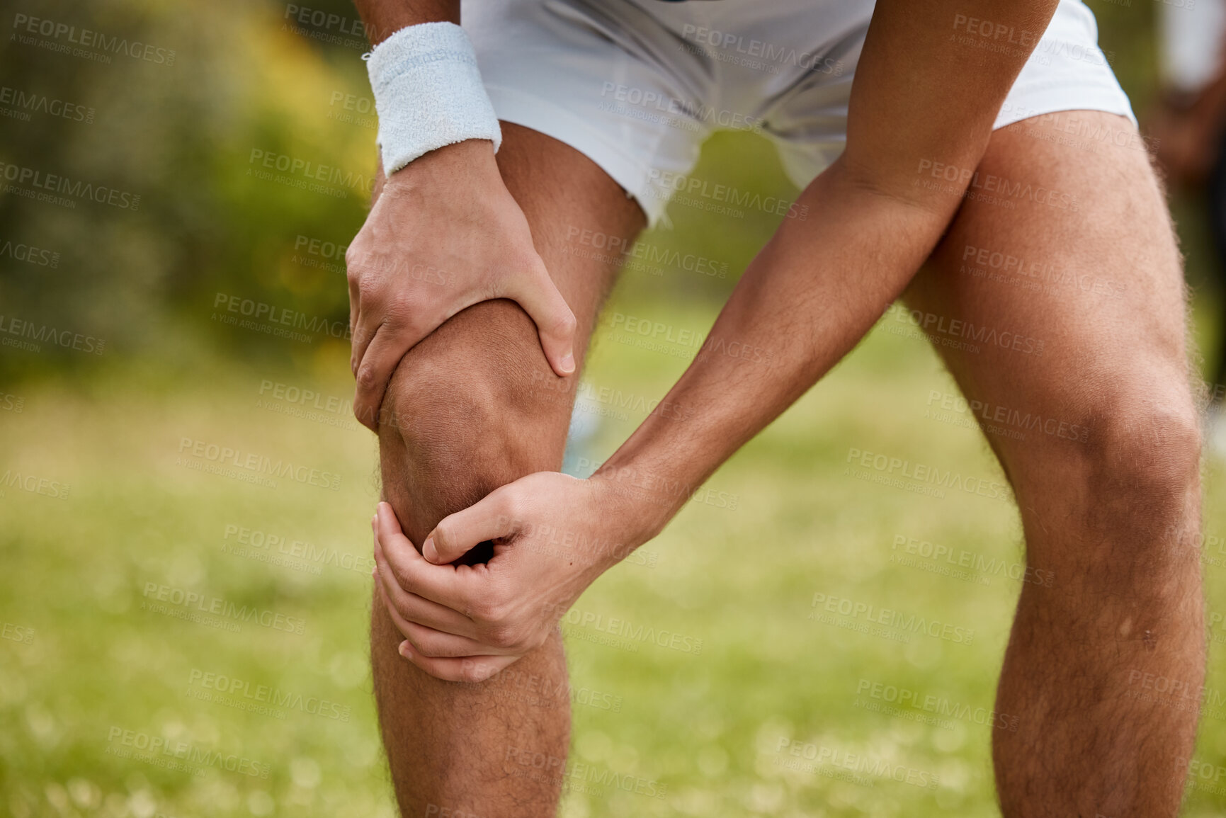 Buy stock photo Hands, knee pain and injury with a sports man closeup outdoor for fitness, training or a workout. Exercise, accident or emergency with an athlete running on a field of grass for a marathon or cardio