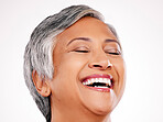Beauty, face and mature woman laugh at funny skincare joke, cosmetics humour or natural facial makeup. Spa salon comedy, eyes closed and studio person smile for dermatology glow on white background