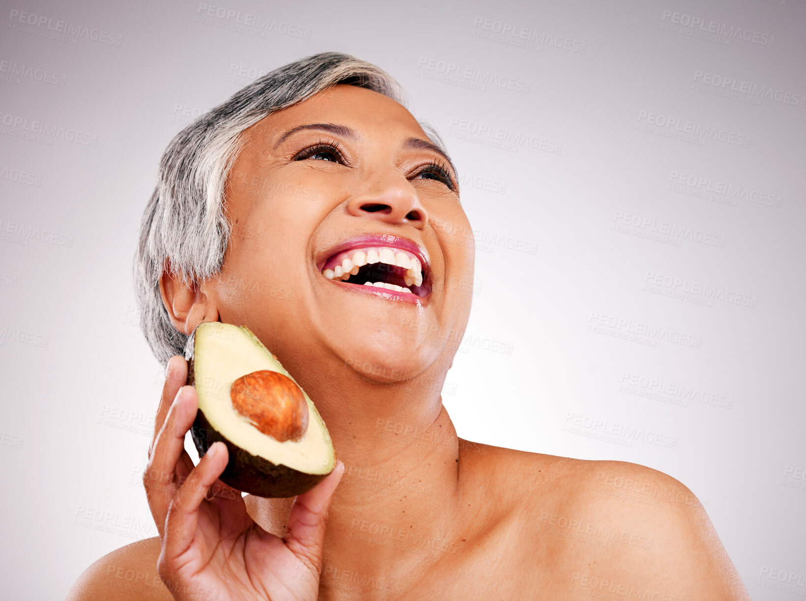 Buy stock photo Happy senior woman, avocado and studio with thinking, results and transformation for skin by white background. Mature female model, fruit and nutrition in diet, beauty and excited for transformation