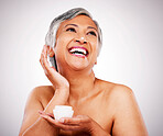 Face cream, skin and beauty of a mature woman with natural glow on a white background. Dermatology, moisturizer and cosmetics of  aesthetic model for facial shine, wellness or self care in studio
