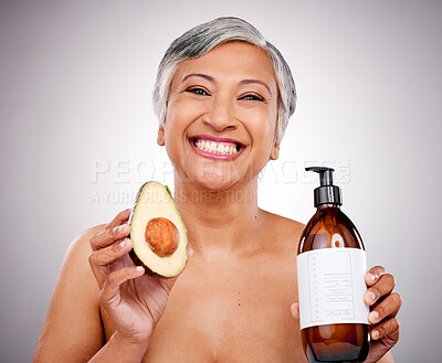 Buy stock photo Mature woman, avocado and studio portrait for bottle, product and promo for nutrition by white background. Senior female model, fruit and excited for cleaning, beauty and skincare with organic oil