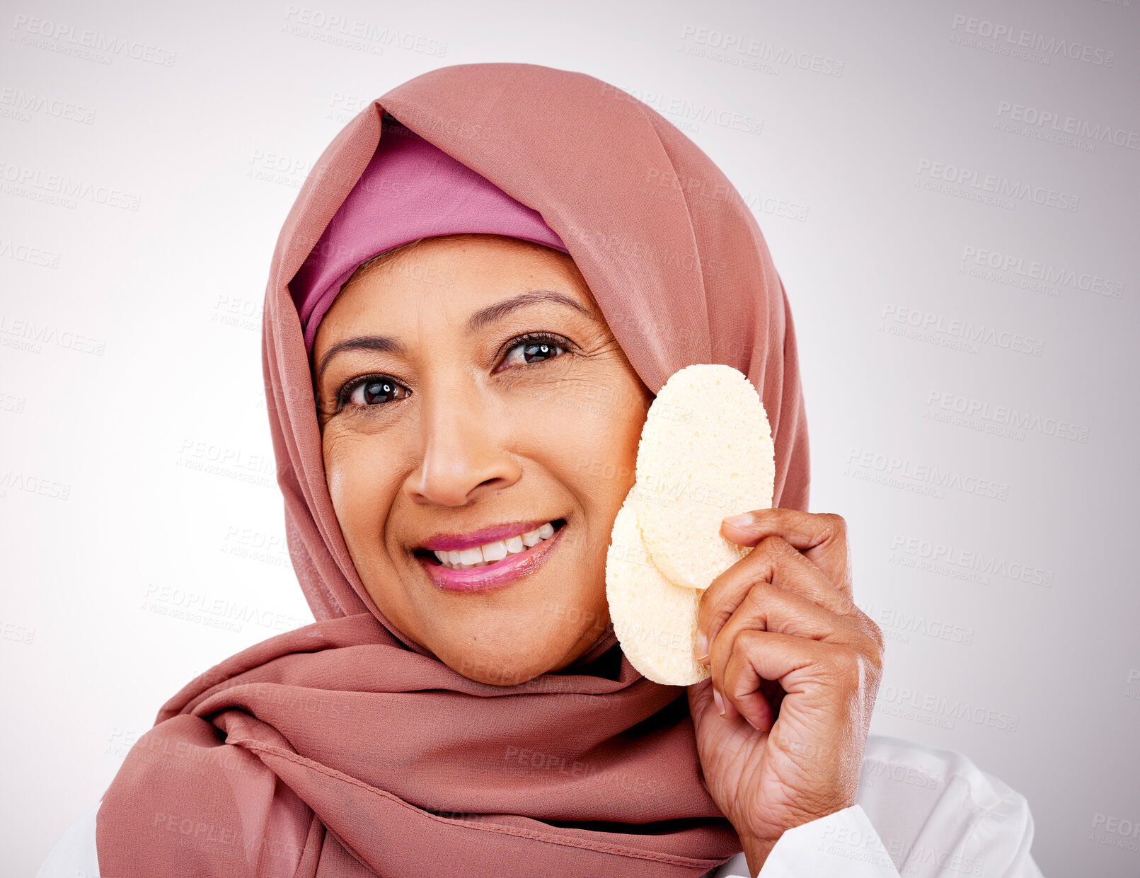 Buy stock photo Skincare, sponge and portrait of Muslim woman in studio with makeup, cosmetics and beauty. Dermatology, happy and face of Islamic person with tools for cleaning, wellness or facial on gray background