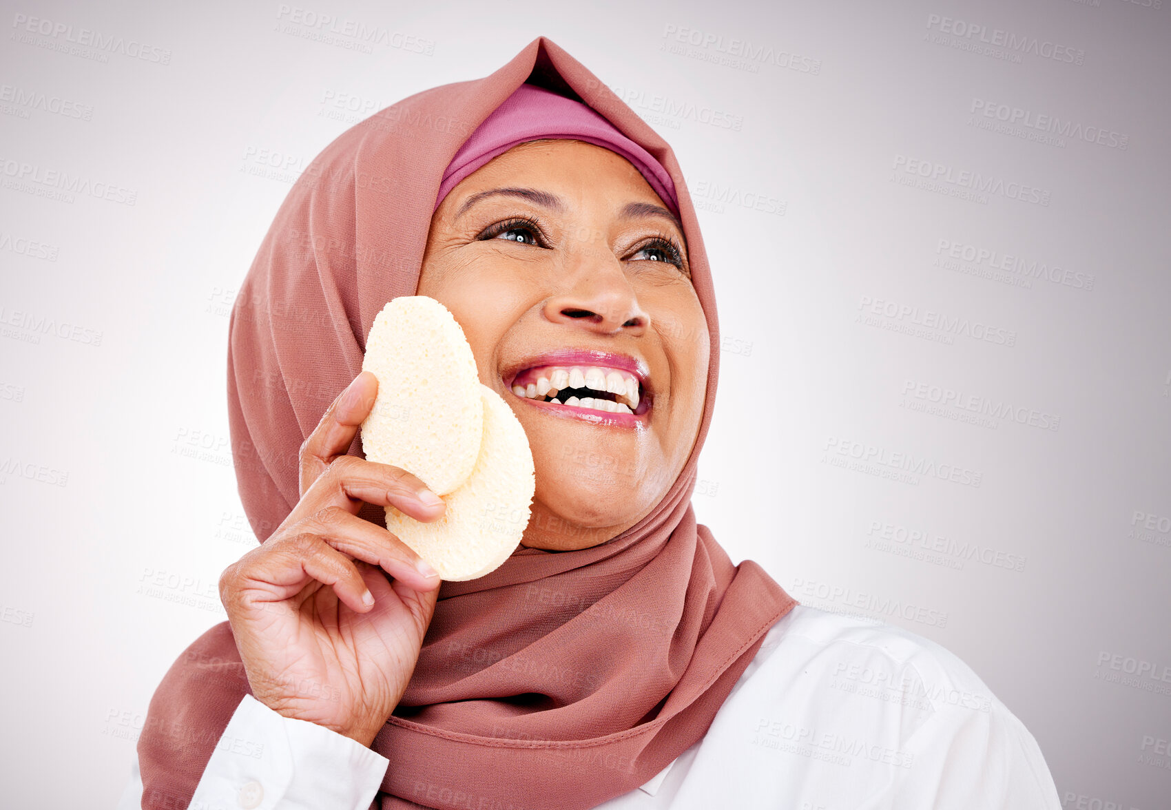 Buy stock photo Skincare, sponge and face of Muslim woman in studio with makeup, cosmetics and beauty. Dermatology, happy and Islamic person with tools for cleaning, wellness and facial care on gray background