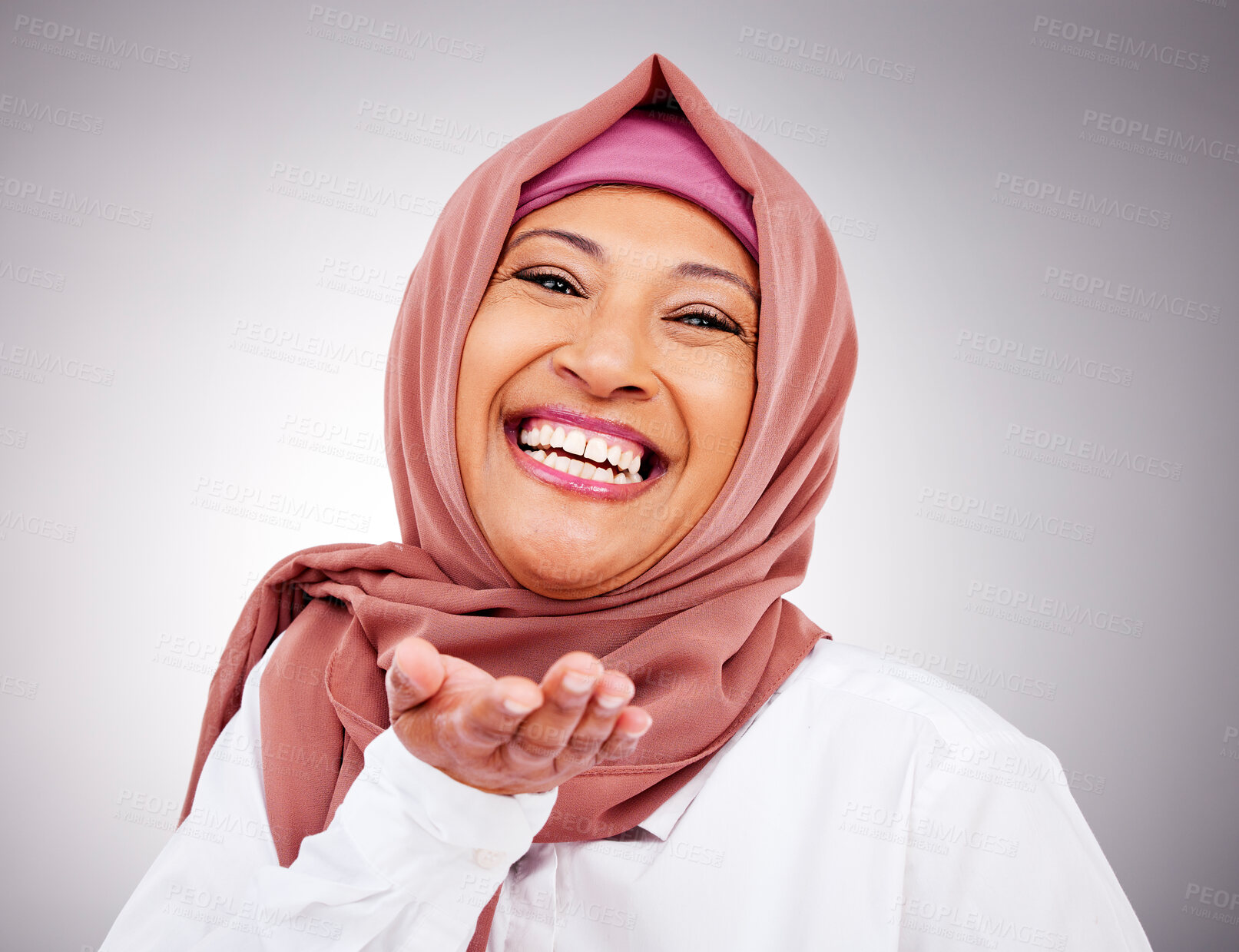 Buy stock photo Blow kiss, happy and portrait of Muslim woman in studio with makeup, cosmetics and beauty. Fashion, style and face  of Islamic person with hand gesture for love, affection or emoji on gray background