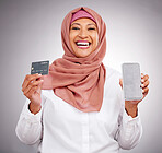 Muslim woman, portrait and credit card with a phone on a studio background for online shopping. Happy, ecommerce and an Islamic person with a mobile app for banking, finance management and payment