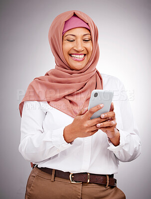 Buy stock photo Muslim, phone and woman with smile in studio for social media scroll, internet post or mobile app on gray background. Smartphone, islam and person with happiness for technology, digital web or joy
 