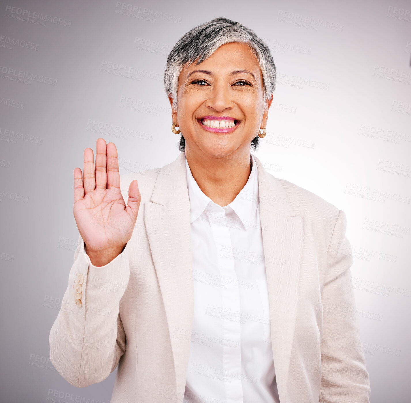 Buy stock photo Portrait, senior woman and hand for a wave, justice or a pledge on a studio background. Happy, face and a mature employee or manager with a gesture for hello, pride or patriotic with respect