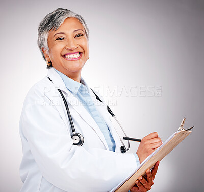 Buy stock photo Happy, notes and portrait of woman or doctor writing feedback, healthcare advice or results. Smile, hospital and mature medical employee or nurse with insurance documents on a studio background