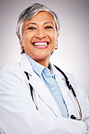 Woman, portrait and doctor smile in studio with arms crossed for consulting of healthcare services. Happy mature surgeon, expert therapist and medical professional with experience on grey background