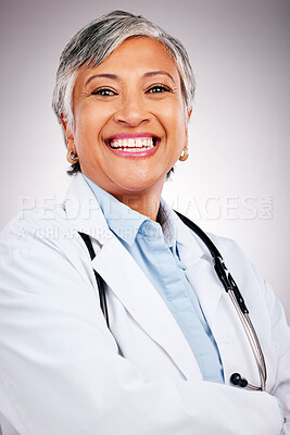 Buy stock photo Woman, portrait and doctor smile in studio with arms crossed for consulting of healthcare services. Happy mature surgeon, expert therapist and medical professional with experience on grey background