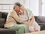 Funny senior women on sofa, friends bonding and relax in home together. Elderly people on couch laughing at joke, comedy or humor in lounge, having fun conversation and retirement chat in living room