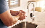 Closeup, water and washing hands in bathroom for hygiene, wellness or disinfection for health. Soap, man and cleaning skin to remove bacteria, virus germs and dirt for safety or protection in home