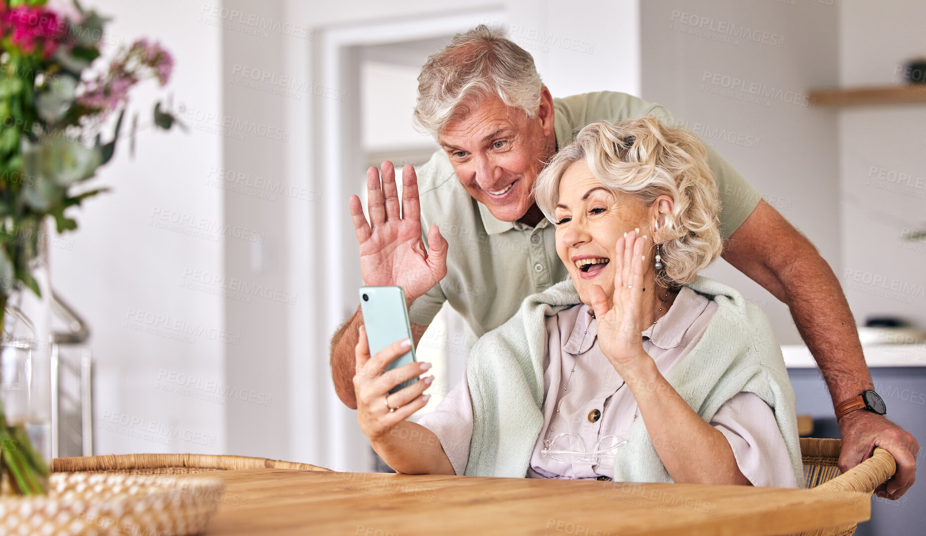 Buy stock photo Senior couple, video call and wave with phone, conversation and contact on social media in retirement. Happy elderly man, woman and webinar with smartphone, smile and hello in morning, house or table