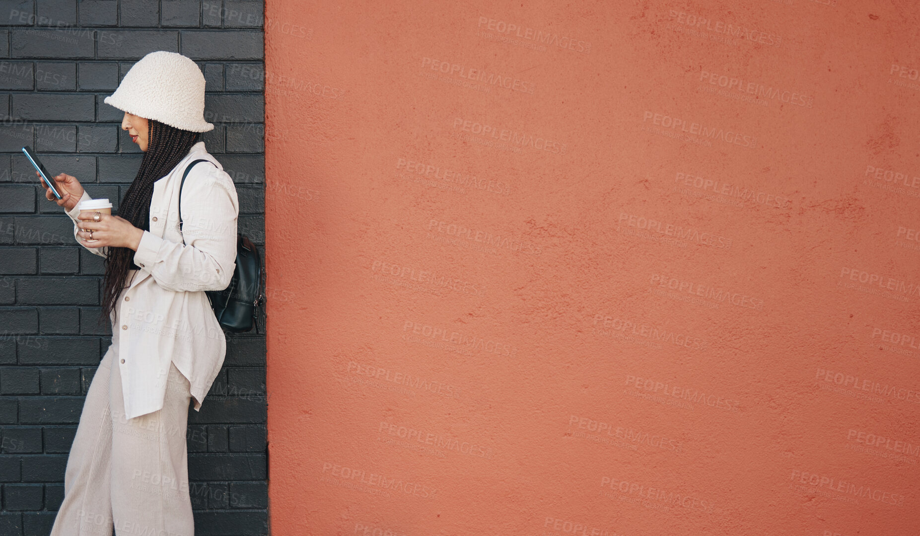 Buy stock photo Woman with phone, brick wall and mockup, urban fashion and typing social media post, chat and coffee. Streetwear, gen z girl or online influencer with smartphone, communication and relax on red space