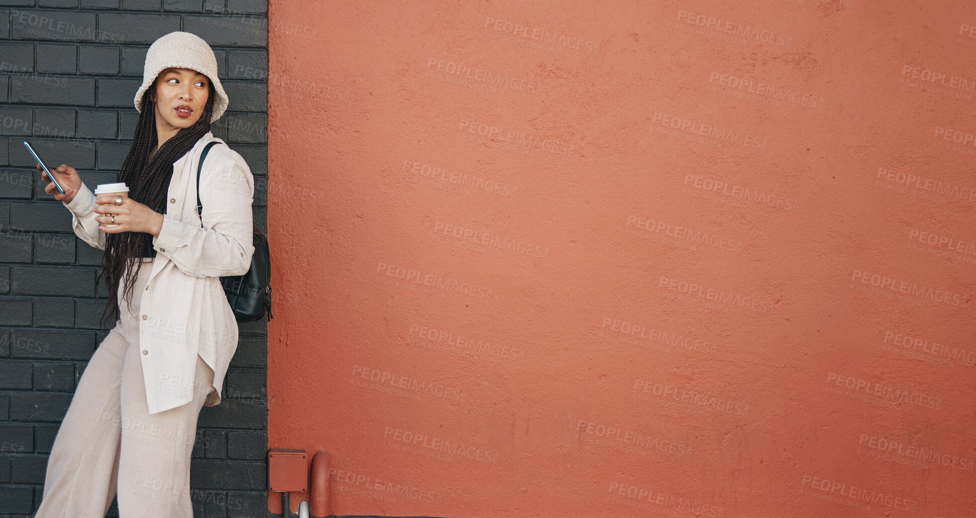 Buy stock photo Woman with phone, wall background and mockup, urban fashion and typing social media, chat and coffee. Streetwear, gen z girl or online influencer with smartphone, communication and relax on red space