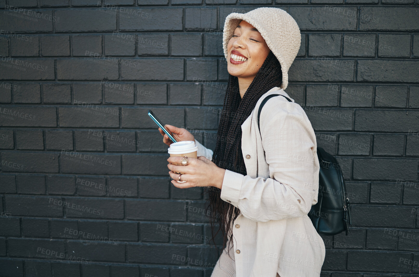 Buy stock photo Happy woman with phone, brick wall and urban fashion, typing social media, chat and laughing. Streetwear, gen z girl or online influencer with smartphone for content creation and meme communication.