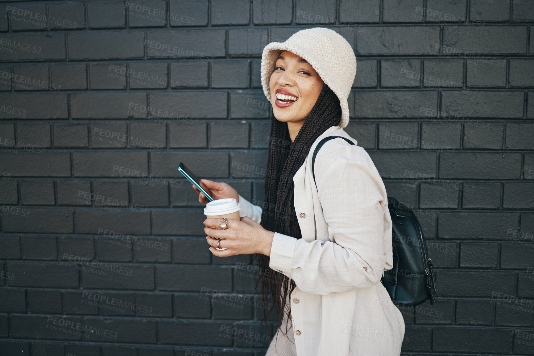 Buy stock photo Portrait of happy woman with phone, wall background and urban fashion, social media chat and internet meme. Streetwear, gen z girl or online influencer with smartphone, smile and communication mockup