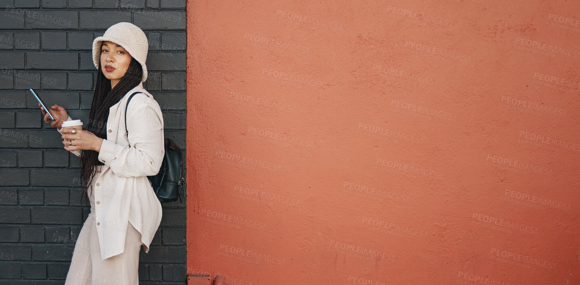 Buy stock photo Portrait of woman with phone, brick wall and mockup, urban fashion and social media chat with coffee. Streetwear, gen z girl or online influencer with smartphone, communication and relax on red space