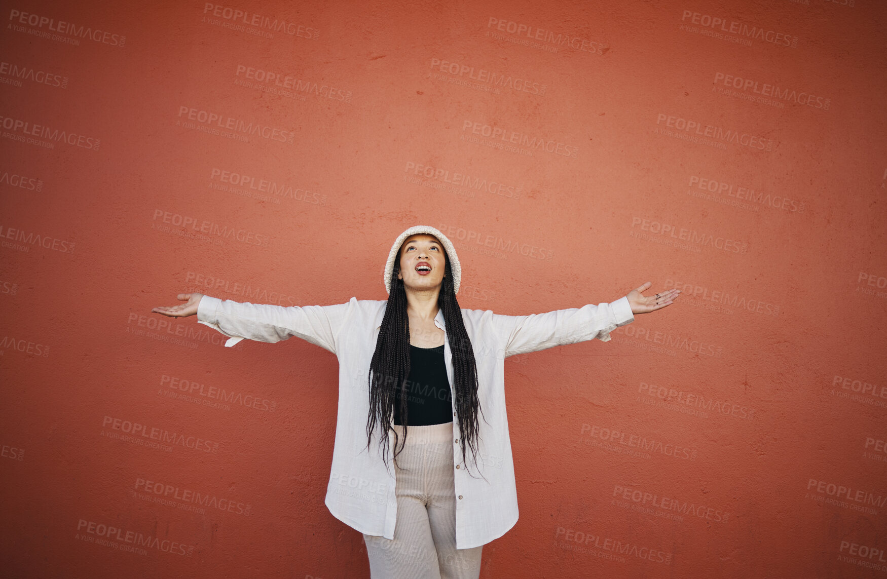 Buy stock photo Excited woman, fashion and arms up for wall and mockup space with urban style and trendy clothing. Freedom, hipster female person and confidence with red background and edgy gen z clothes of a girl