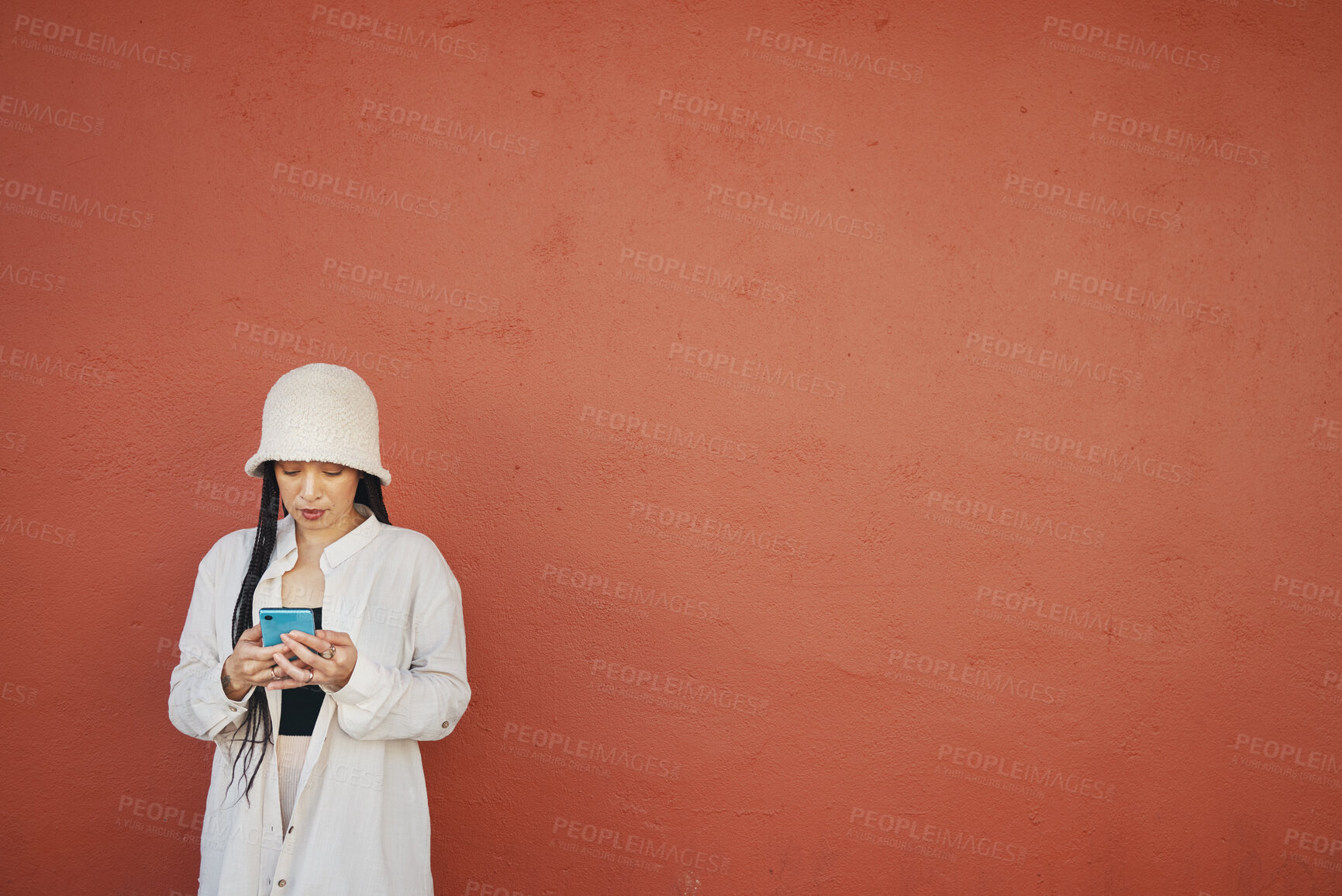 Buy stock photo Mockup, wall and woman with phone in a city for travel, search or location map on orange background. Smartphone, app and lady fashion influencer outdoor on social media, blog podcast content creation