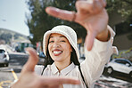 Happy woman, portrait and selfie in city for photography, fashion or outdoor memory in travel. Female person smile with hands framing face for photograph, picture or social media tour in urban town