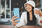 Phone, selfie and woman with a coffee in the city at a cafe on a weekend adventure with happiness. Smile, fun and young female person drinking latte and taking a picture on cellphone outdoor in town.