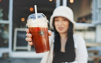 Buy stock photo Woman hand, smoothie and closeup outdoor at a restaurant and drink from cafe. Milkshake, coffee shop and gen z fashion of a female person with a straw on break on diner patio with blurred background