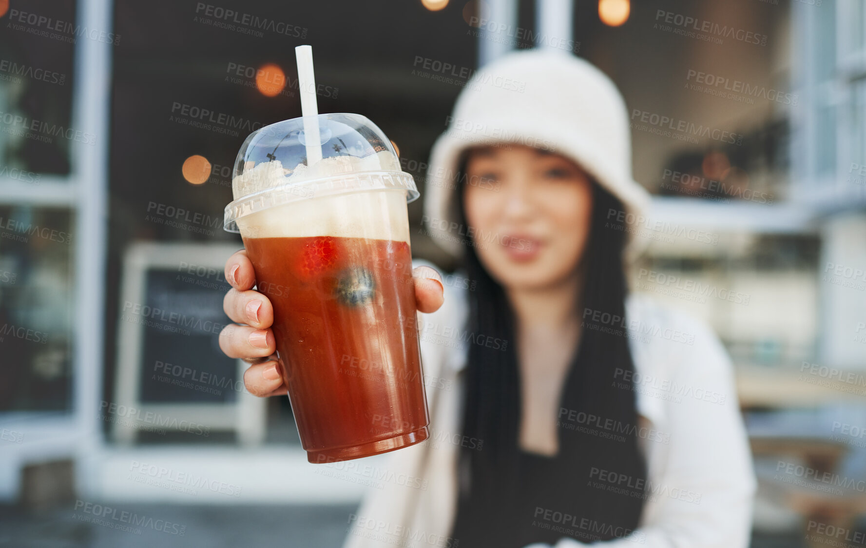 Buy stock photo Woman hand, smoothie and closeup outdoor at a restaurant and drink from cafe. Milkshake, coffee shop and gen z fashion of a female person with a straw on break on diner patio with blurred background