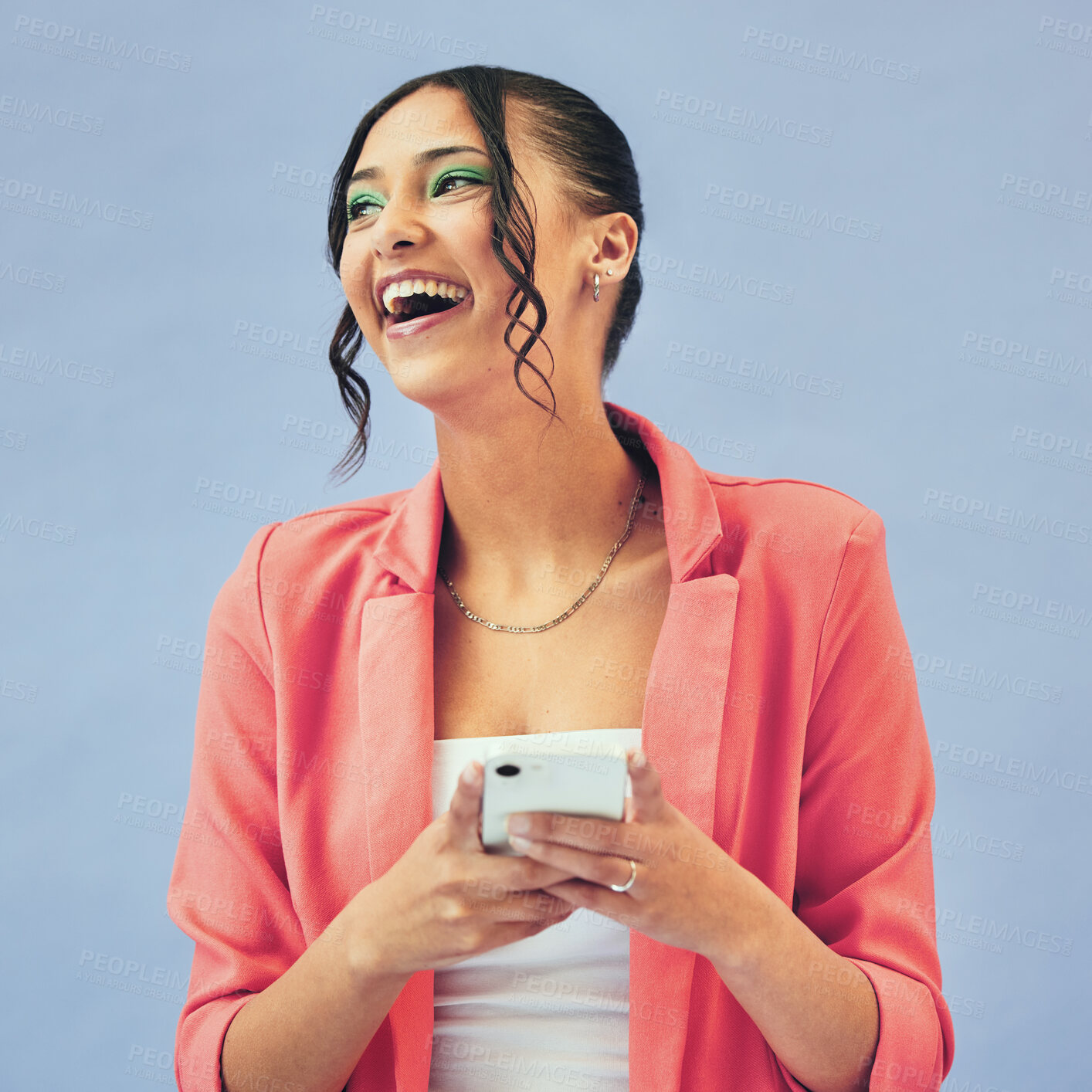 Buy stock photo Happy, face and woman with phone in studio laughing at social media, joke or meme on blue background. Smartphone, app and female model with gif communication, joke or funny chat, text or blog comic