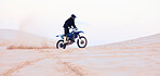 Sand, dust or athlete driving motorcycle for action, adventure or fitness with performance or adrenaline. Desert, sports or person on motorbike on dunes for training, exercise or race or challenge