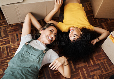 Buy stock photo Top view, lesbian and couple on the floor, boxes and funny with love, bonding and homeowners. Queer people, lgbtq and women on the ground, new apartment and property with achievement and real estate