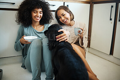 Buy stock photo Friends, dog and happy morning in kitchen, home or women with coffee, drink and eating breakfast on the floor of apartment. Couple, animal or pet in house with love, care and support from girls