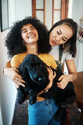 Buy stock photo Dog, hug and happy lesbian couple in home, bonding or having fun together. Pet, gay women smile and embrace animal for care in healthy relationship, love connection and funny laugh of lgbtq people