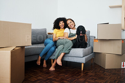 Buy stock photo New home, portrait and lesbian couple with a dog on the sofa for moving boxes and relocation. Smile, lgbt and women or people on the living room couch of an apartment with a pet and a homeowner