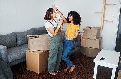 Buy stock photo Homeowner, lesbian and celebration with couple, boxes and excited with happiness, achievement and property. Queer people, happy girls and women with cardboard, real estate and relationship with goals