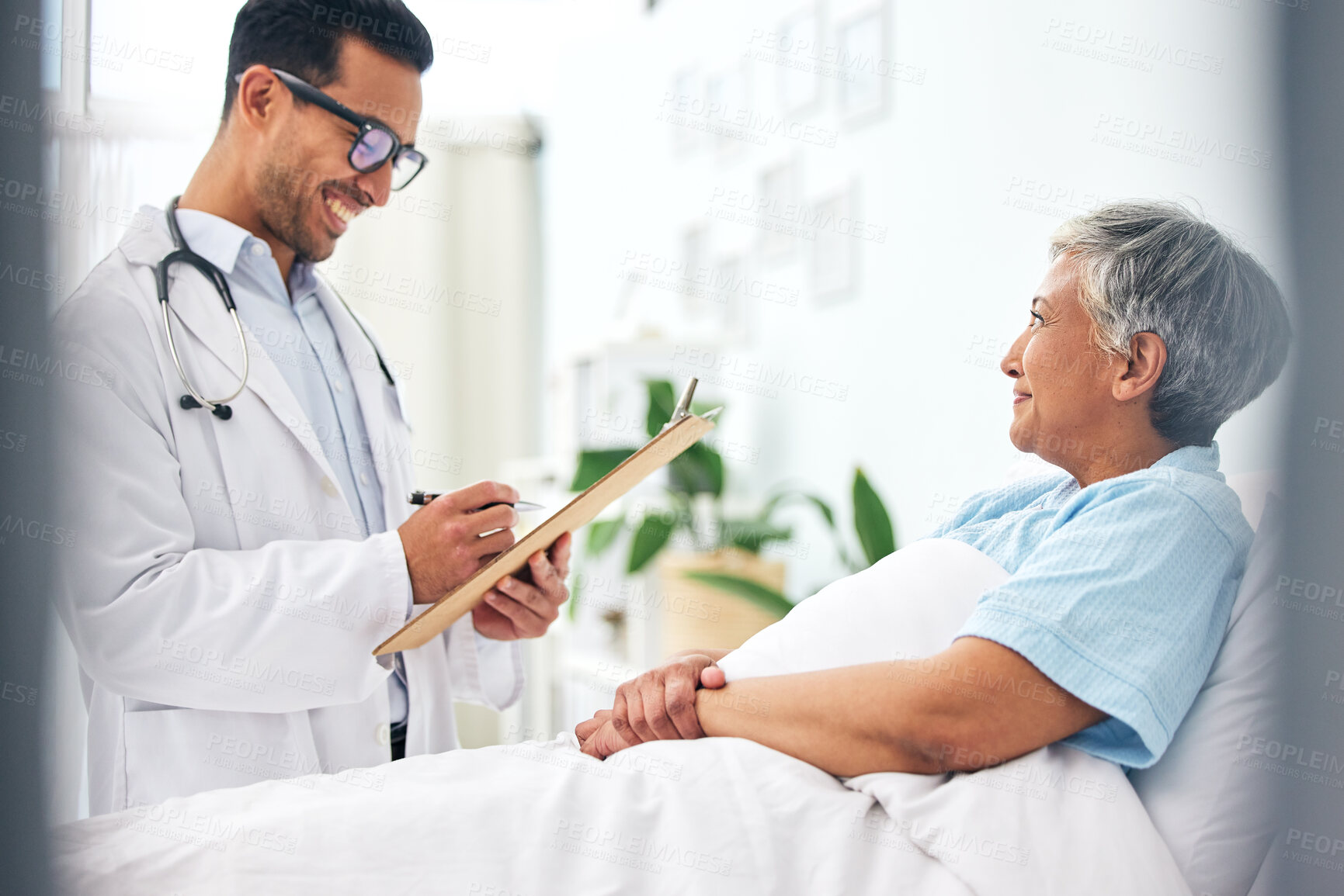 Buy stock photo Happy woman in bed, doctor with medical chart and checklist for health insurance, consultation and advice. Smile in hospital, healthcare professional with patient information, results and talking.