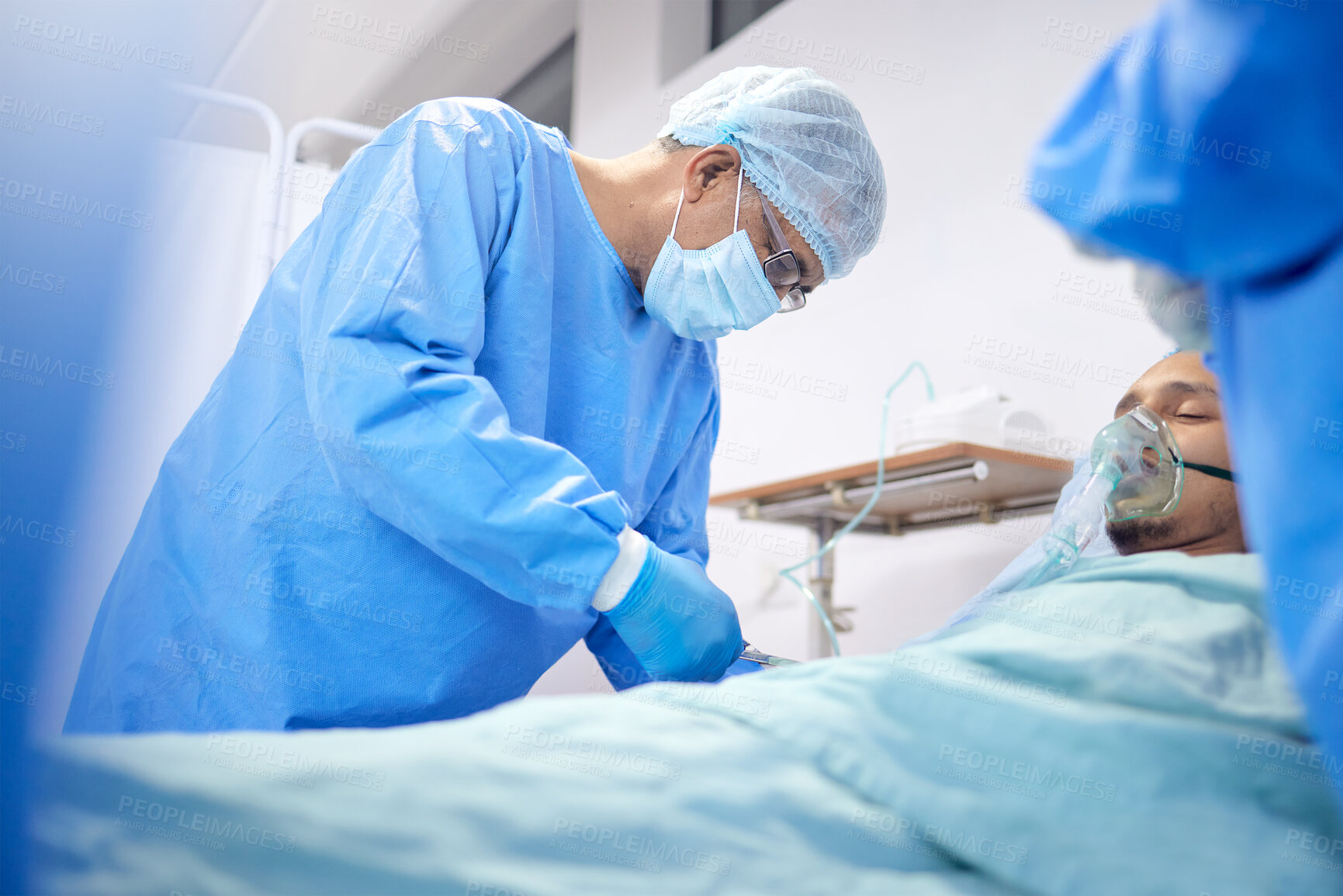 Buy stock photo Patient, hospital and surgeon team or emergency service for healthcare or medical procedure. Doctors with a man to start collaboration, oxygen or surgery and operation with support and scrubs in ICU