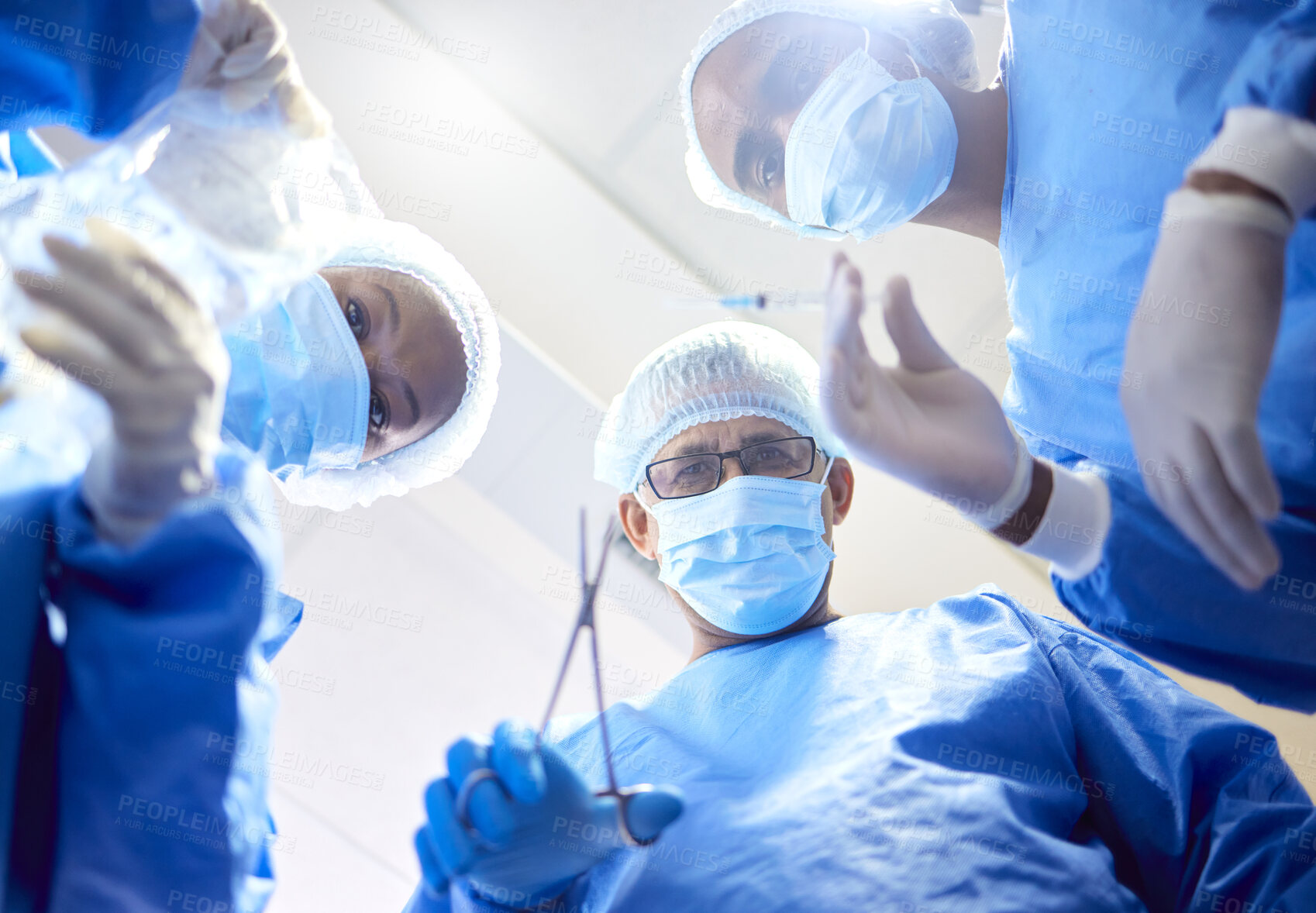 Buy stock photo Hospital, tools and surgeon team in theatre for emergency, healthcare or medical procedure. POV, below and doctors for collaboration, portrait or surgery and operation with support and scrubs in ICU