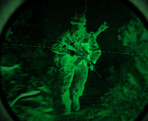 Dark, night vision and soldier in the military, war or mission for army with surveillance, security or agent of government. Green, man or person with overlay of sniper telescope view or enemy