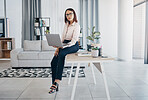 Portrait, woman and office with laptop, working and thinking in corporate clothes, alone and serious. Sitting on desk, virtual meeting and writing report for client review and business manager stats
