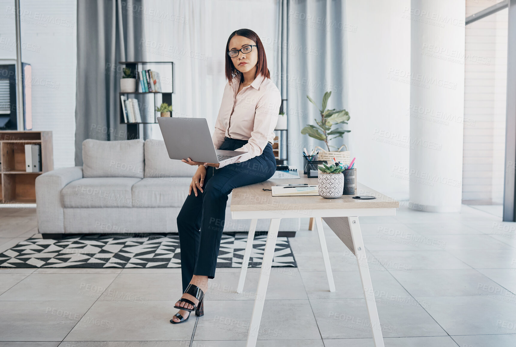 Buy stock photo Portrait, woman and office with laptop, working and thinking in corporate clothes, alone and serious. Sitting on desk, virtual meeting and writing report for client review and business manager stats