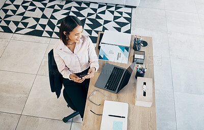 Buy stock photo Smartphone, laptop and business woman at table in home living room on social media, research and freelancer typing. Happy designer on phone at desk, reading email and communication for remote work