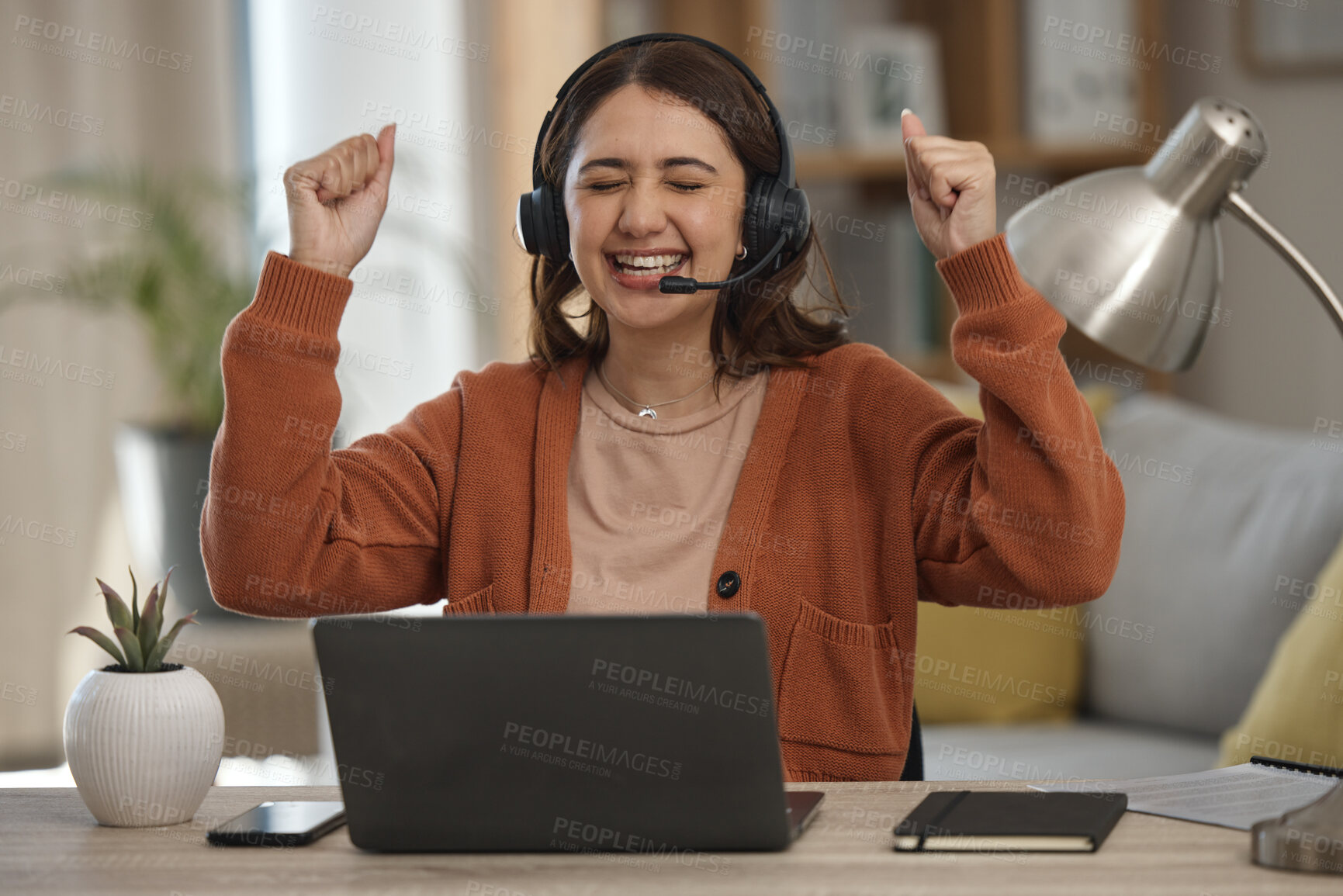 Buy stock photo Woman, headset and laptop in celebration at home with goal, achievement and victory. Female person, consultant or employee with arms up in happiness on video call, telemarketing or support to clients