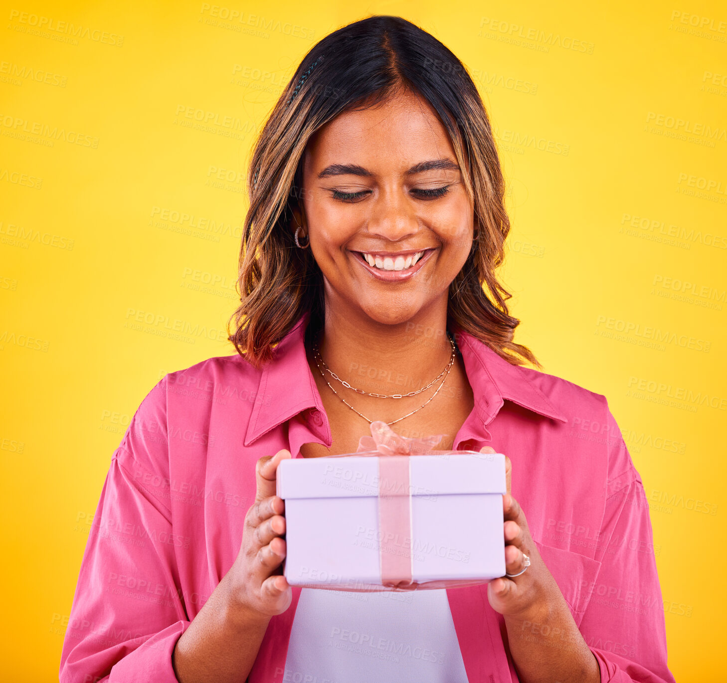 Buy stock photo Happy woman, gift box and present for birthday, event or winning against a yellow studio background. Female person smile with prize, giveaway or celebration for surprise, package or ribbon parcel