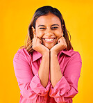 Woman, smile and happy with hands on face, portrait and closeup in studio with yellow background. Indian girl, self love and positive, satisfaction and confidence with hand gesture, style and fashion