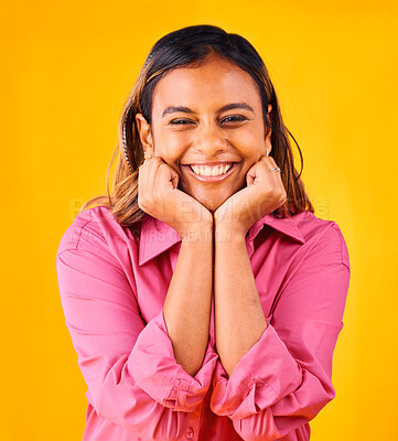 Buy stock photo Woman, smile and happy with hands on face, portrait and closeup in studio with yellow background. Indian girl, self love and positive, satisfaction and confidence with hand gesture, style and fashion