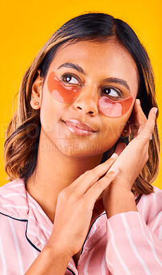 Buy stock photo Eye mask, beauty and woman in a studio with skincare, dermatology and cosmetic product. Glow, smile and young female model from Mexico with facial patch for self care treatment by yellow background.