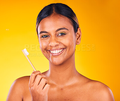 Woman, toothbrush in portrait with smile and dental in studio, health and wellness on yellow background. Bamboo brush, eco friendly orthodontics and teeth whitening for oral care and fresh breath