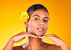 Woman, rose and natural beauty for skincare, dermatology and cosmetics portrait on yellow background. Spring, eco friendly treatment for self care, facial for antiaging with flower and glow in studio